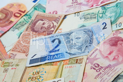 Background from paper money of the different countries. Brazilian real in the middle