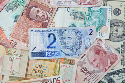 Background from paper money of the different countries. Brazilian real in the middle