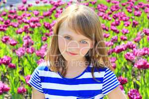portrait beautiful young girl on lilac tulips background