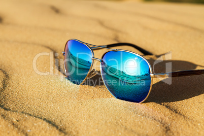 Sunglasses on the sand in the desert.