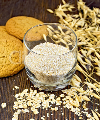 Bran small oat in glass with cookies on board