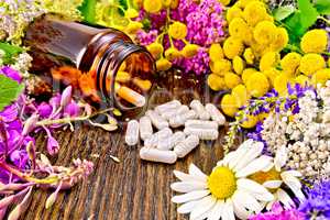 Capsules in brown jar with flowers on board