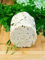 Cheese homemade with spices and herbs on board