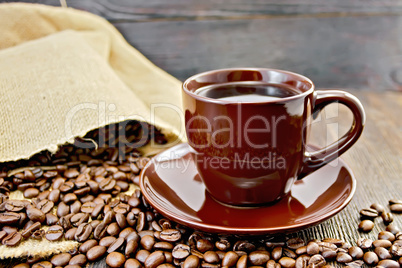 Coffee in brown cup with bag on board