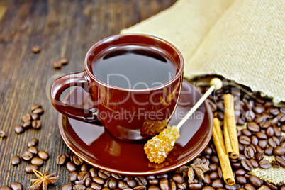 Coffee in brown cup with sugar and bag on board