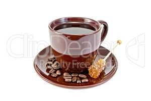 Coffee in brown cup with sugar and grains