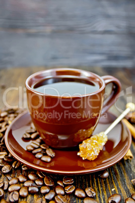 Coffee in brown cup with sugar and grain on board