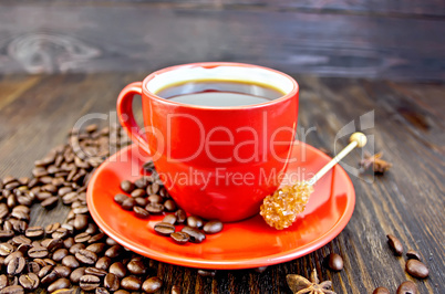 Coffee in red cup with sugar on board