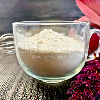 Flour amaranth in cup with mixer on board