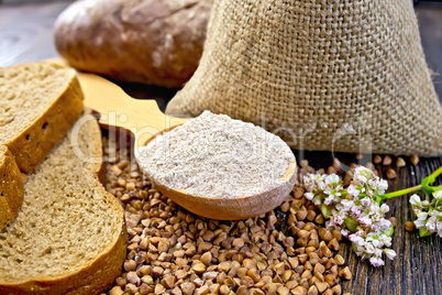 Flour buckwheat in spoon with cereals and bread on board