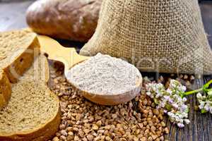 Flour buckwheat in spoon with cereals and bread on board