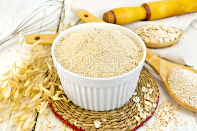 Flour oat in white bowl on light board