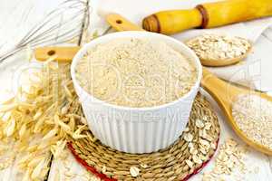 Flour oat in white bowl on light board