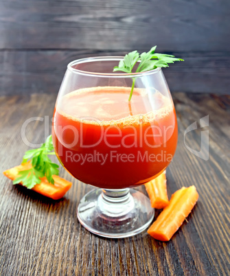 Juice carrot with parsley in wineglass on board