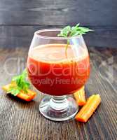 Juice carrot with parsley in wineglass on board