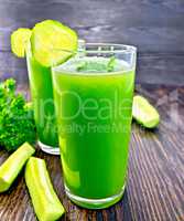 Juice cucumber in two tall glass on board