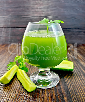 Juice cucumber in wineglass on dark board