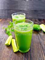 Juice cucumber with parsley in two glass on board