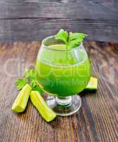 Juice cucumber with parsley in wineglass on board
