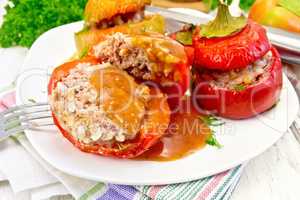 Pepper stuffed meat and rice with sauce in plate on table