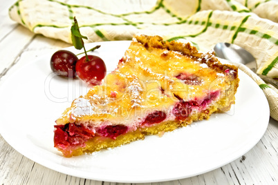 Pie cherry with sour cream in white plate on board