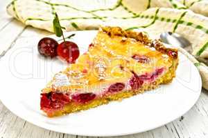 Pie cherry with sour cream in white plate on board