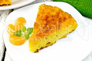 Pie mandarin with mint and napkin on light board