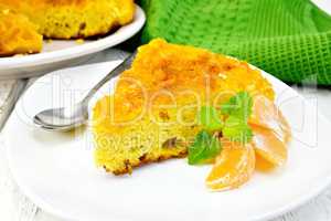 Pie mandarin with mint and spoon on light board