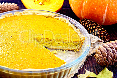 Pie pumpkin in glass pan on board