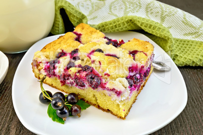 Pie with black currant in plate on board