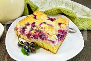 Pie with black currant in plate on board