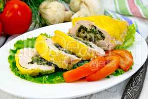 Roll chicken with mushrooms on salad in plate