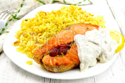 Salmon with sauce and rice on board