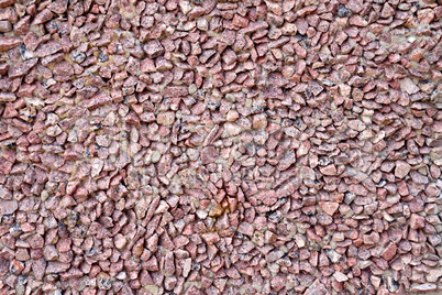 Wall of red granite gravel