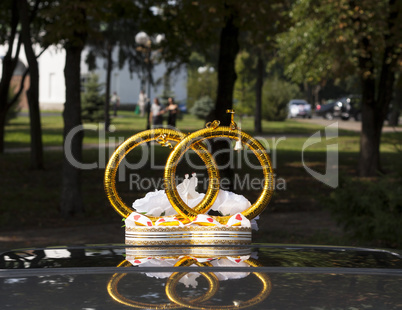 Wedding car decoration with flowers and rings