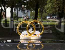 Wedding car decoration with flowers and rings