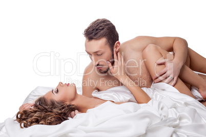 Erotica. Man passionately hugging woman in bed
