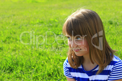 portrait of girl on the green grass background