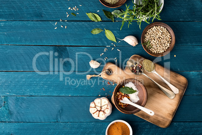 culinary background with spices on wooden table