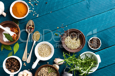 culinary background with spices on wooden table