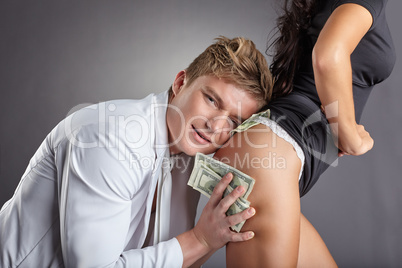 Image of pleased man hugging sexy stripper