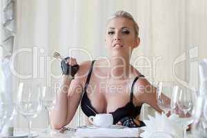 Hot blonde posing in lingerie at dinner table