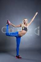 Pretty pilates instructor posing in studio