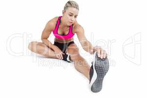 Female athlete sitting and stretching