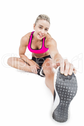 Female athlete sitting and stretching