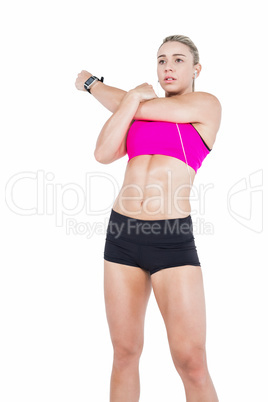 Female athlete stretching and listening music
