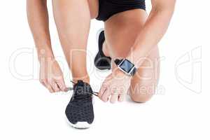 Female athlete tying her shoelace