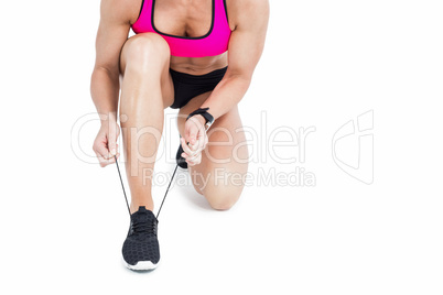 Female athlete tying her shoelace