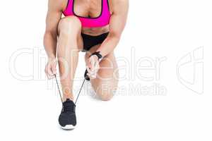 Female athlete tying her shoelace