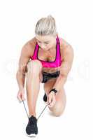 Female athlete tying her shoelace